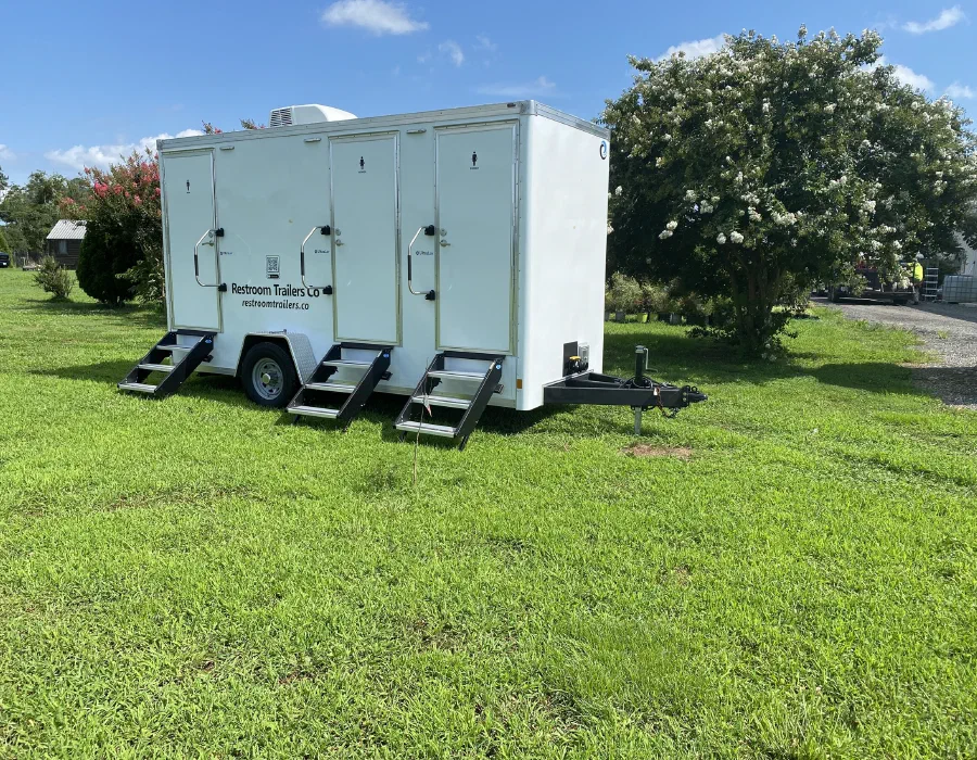 Trailer set up on a lawn with all three sets of steps down