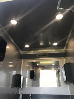 Recessed ceiling lighting and window in the restroom trailer interior